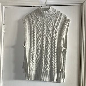 Higher neck open vest. Trendy for over blouses or crew shirts. Grey.